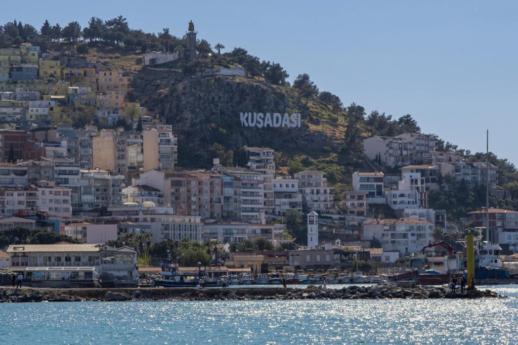 View of the Kusadasi Sign and Hillside Houses in Kusadasi, Turkey